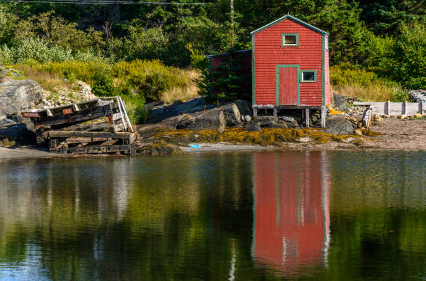 istock Red Shed Reflecting onto the Ocean 1036379882
