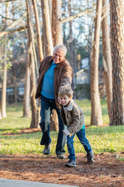 istock Senior man and grandson having fun at park 1036385304