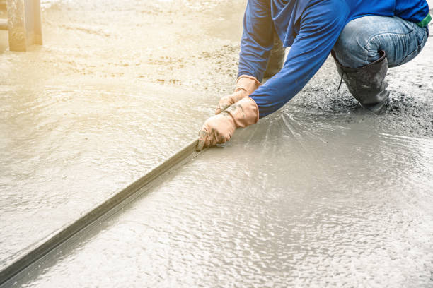 istock Man sitting and using a wooden spatula for cement after Pouring ready-mixed concrete 1036417010