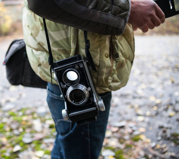 an antique camera and on a tripod