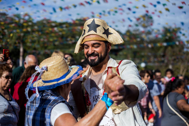 Guarulhos, SP, Brazil - June 24, 2018: A Man wearing typical clotes of Junina Party(festa junina), dancing, playing music and smiling
