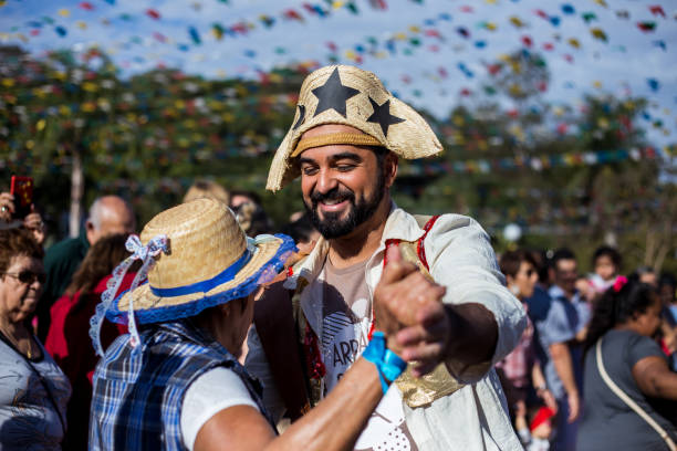 view of man in typical brasilian event, Junina Party Guarulhos, SP, Brazil - June 24, 2018: A Man wearing typical clotes of Junina Party(festa junina), dancing, playing music and smiling arraial do cabo stock pictures, royalty-free photos & images