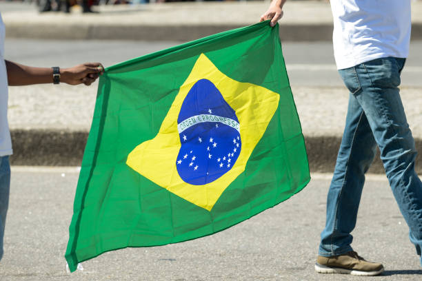 istock two people holding the brazilian flag 1036441558