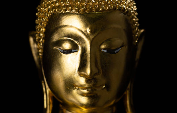 istock Golden buddha statue isolated on black background 1036444672