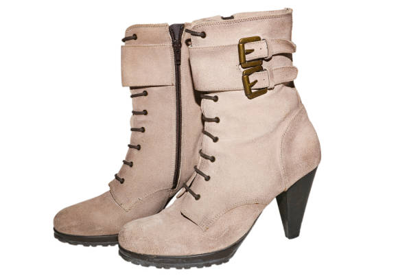 istock Women's suede ankle boots heels metal buckle on an isolated background 1036472964