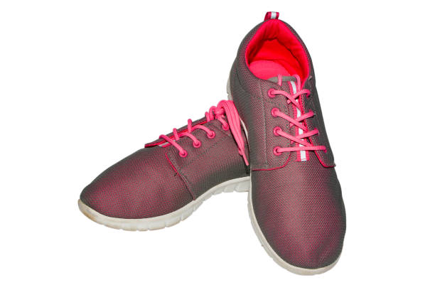 istock Pink sneakers with laces on a white sole on the isolate. 1036473082