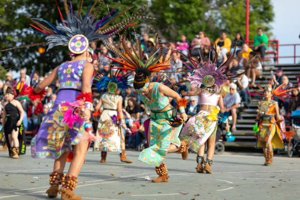 Indian Summer Festival Milwaukee, Wisconsin, USA - September 8, 2018 The Indian Summer Festival: Men women and children members of the Dance Academy of Mexico performing Aztec Dance indegious culture stock pictures, royalty-free photos & images