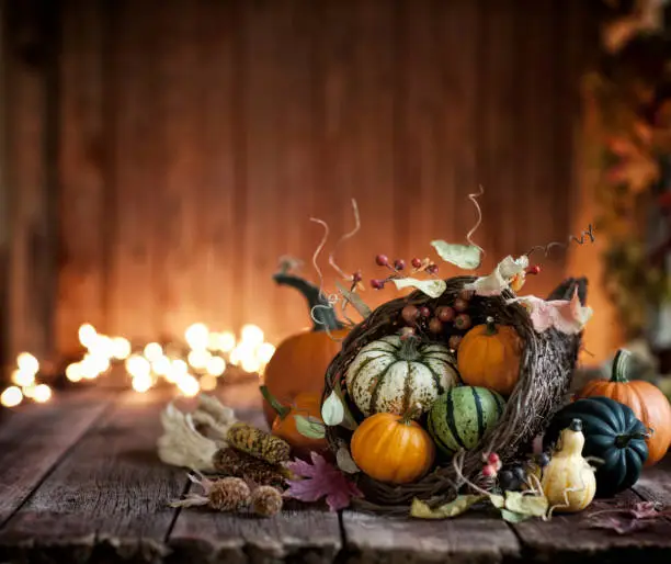 Photo of Autumn Thanksgiving Cornucopia on a Rustic Wood Background