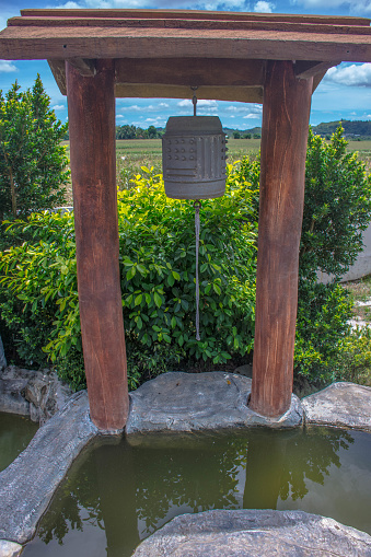 Color image of Buddhist prayer bell over a reflection pond in northern Luzon, Philippines