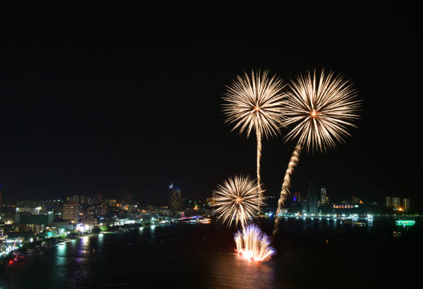 Multicolor fireworks night scene, closeup with pattaya cityscape sea beach view, thailand