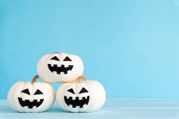 istock White ghost pumpkin on sky blue background. halloween concept. 1036538526