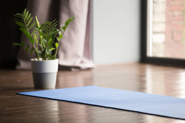 istock Yoga mat on the floor, blue carpet 1036550422