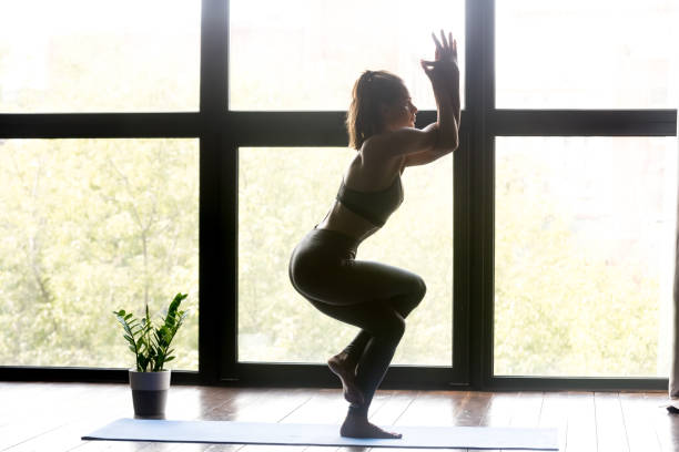 istock Young sporty woman doing yoga Eagle exercise 1036550518