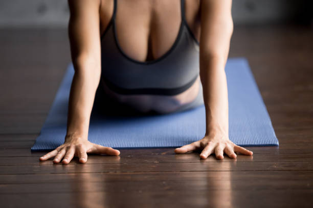 istock Sporty woman doing Cobra exercise, close up 1036550544