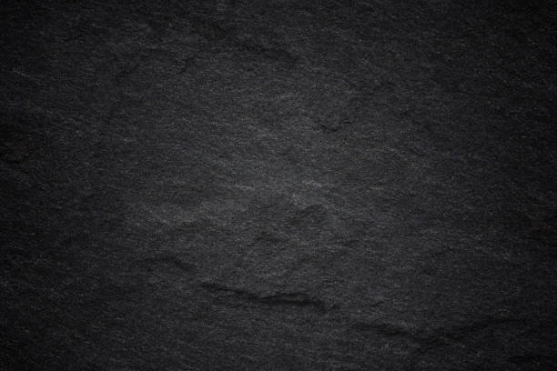 istock Dark grey black slate background or natural stone texture. 1036550782