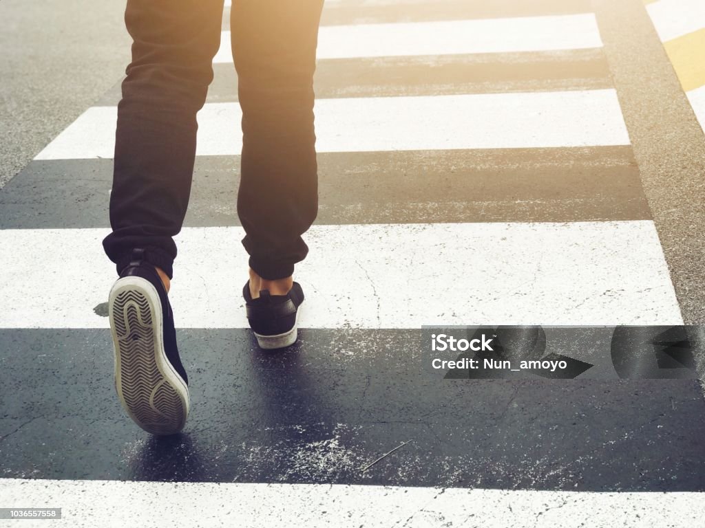 Close up feet walking safety crosswalk on road, walkway safety signs symbol Pedestrian Stock Photo