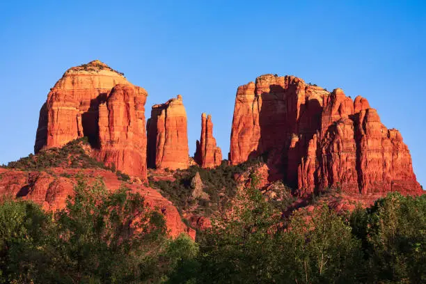 Cathedral Rock, a famous red rock landmark and popular travel destination in Sedona, Arizona at sunset.