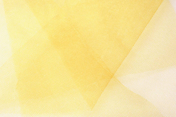 istock Texture, background, pattern. Yellow silk fabric.Smooth elegant golden silk can use as background. Golden satin textile background. 1036560554
