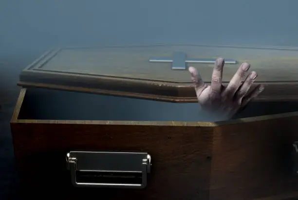 Photo of Open Coffin And Hand