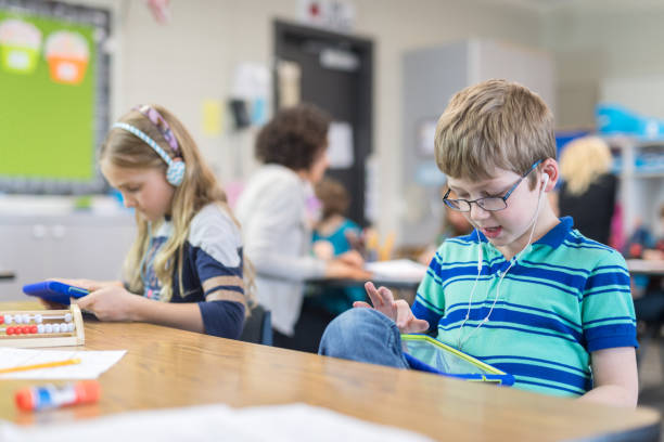 istock First grade boy working on a digital tablet at his desk 1036563340