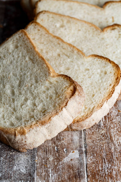 istock Fresh baked bread and sliced bread on rustic wooden table 1036563540