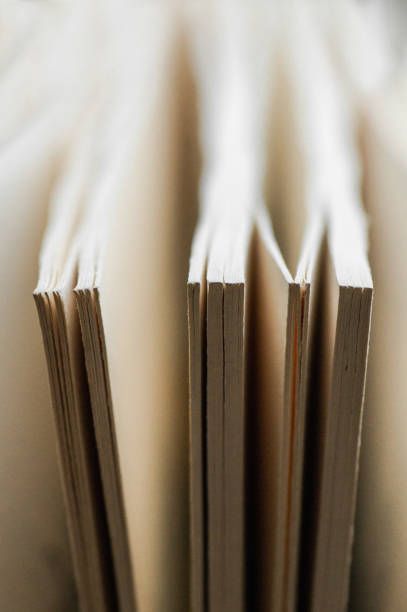 istock Chaotic stack of old books pastel colors, selective focus with copy space. Background from books. Books close up. 1036579502