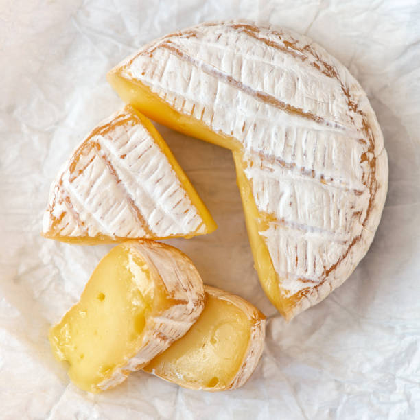 istock A soft ripened Camembert cheese on white background. Top view 1036586356