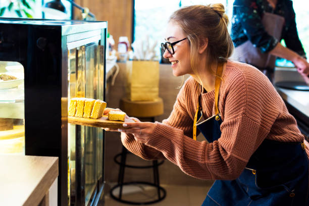 istock Woman getting cake out of the display fridge 1036586724
