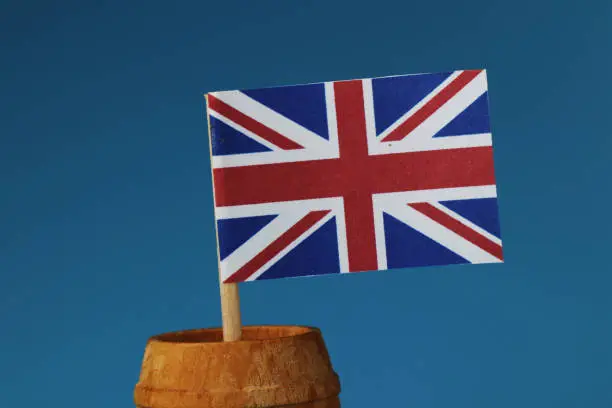 Photo of A detail on paper national flag of united kingdom on wooden stick in wooden barrel