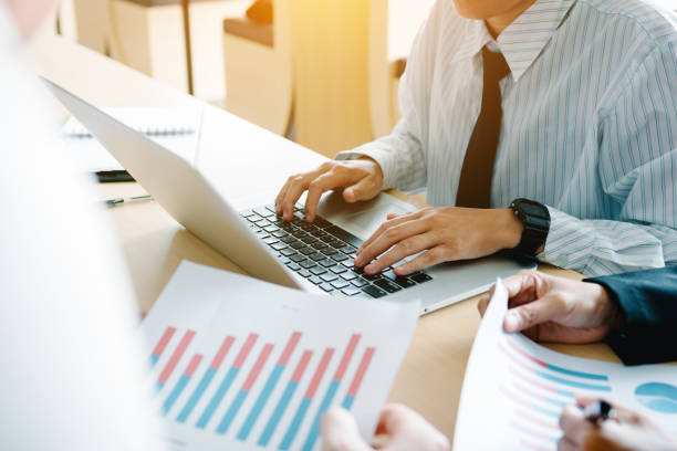 istock Team business people analysis summary report graph in office room. 1036590764