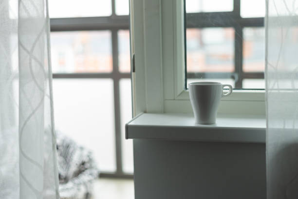 istock A cup of coffee on the windowsill. Big window. Scandinavian style 1036595998