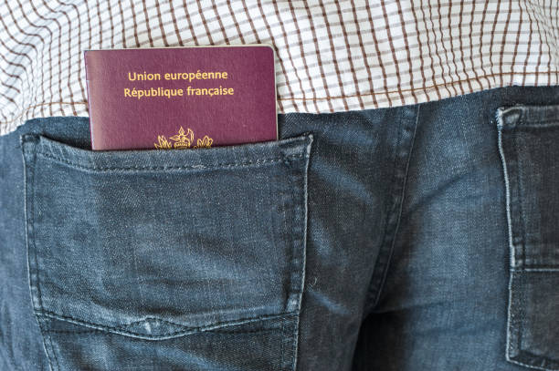Man with a french passport in the pocket stock photo