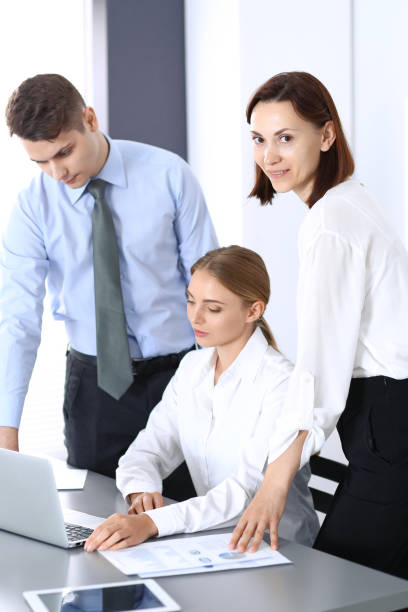 istock Group of business people using laptop computer  in office. Meeting and teamwork concept. 1036605554