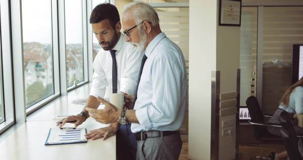 istock Senior boss consulting young subordinate 1036607070