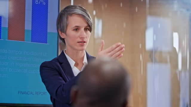 Caucasian woman with short haircut holding a presentation in the conference room