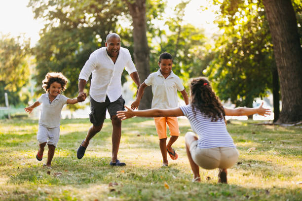 istock Little boys and father running toward their mother 1036612456