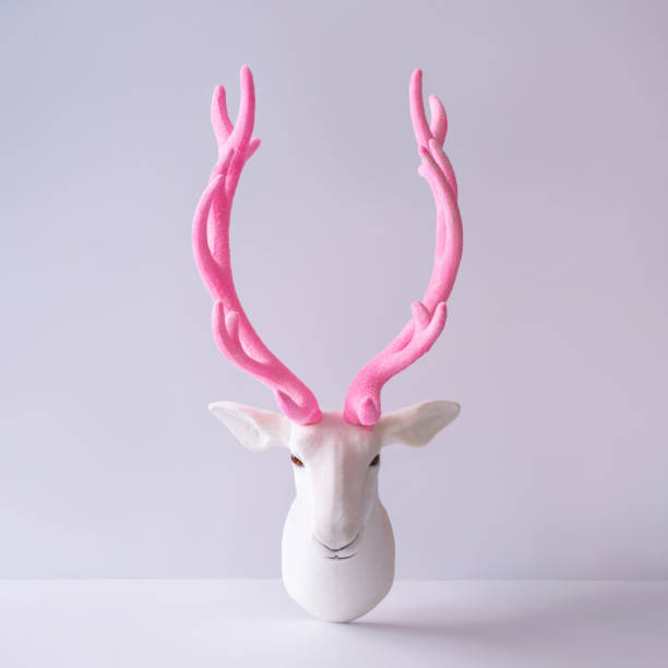 istock White reindeer with glitter pink antlers. 1036616670