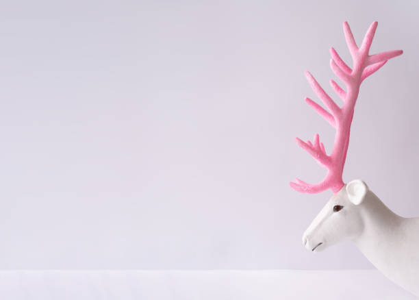 istock White reindeer with glitter pink antlers. 1036616830