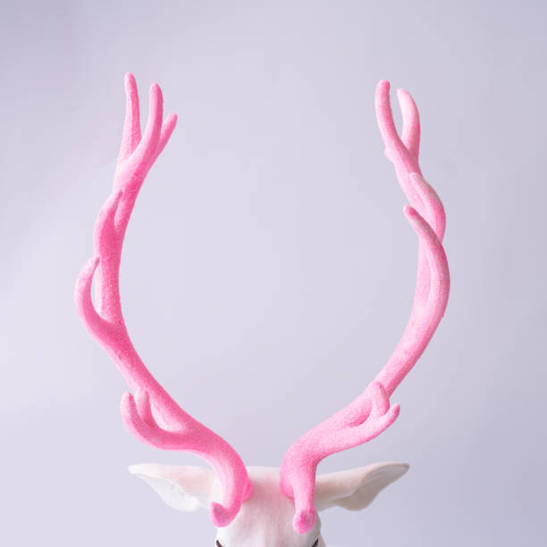 istock White reindeer with glitter pink antlers. 1036616850