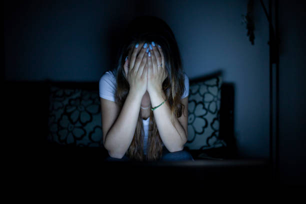 Oh no, I can't watch this Girl sitting alone in dark room can't watch some scare scene on a laptop conspiracy photos stock pictures, royalty-free photos & images