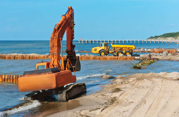 istock coastal protection measures, construction equipment on the shore, the construction of breakwaters 1036622080