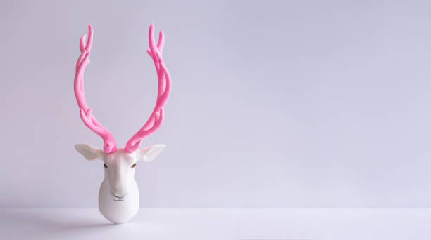 istock White reindeer with glitter pink antlers. 1036627556