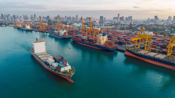 istock Container ship from sea port working for delivery containers shipment and container warehouse background. Suitable use for transport or import export to global logistics concept. 1036636940