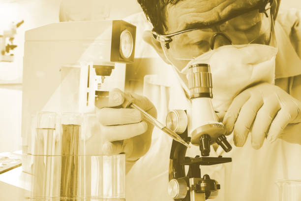 istock Double exposure microscope and Laboratory glassware or test tube . science concept. 1036642936