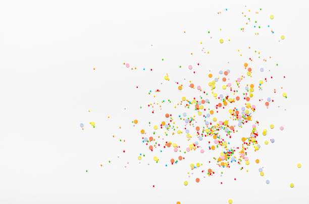 Sugar sprinkle dots on white background. Sweet decoration for cakes. Top view, copy space.