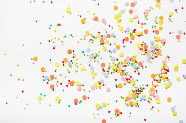 istock Sugar sprinkle dots on white background. Sweet decoration for cakes. Top view 1036645052
