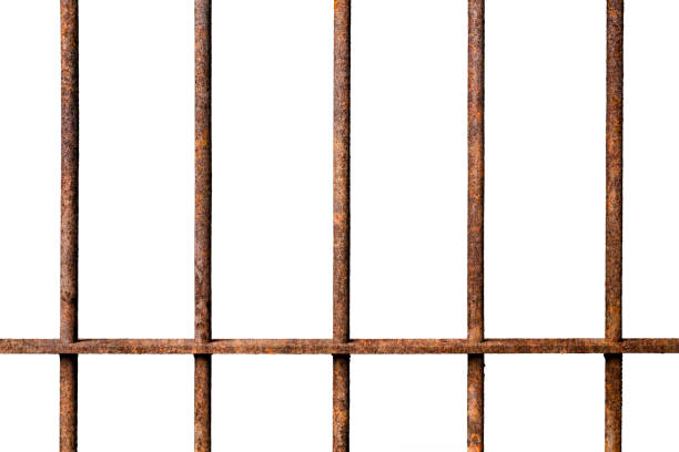 istock Old prison rusted metal bars cell lock isolated on white backgroun 1036645312