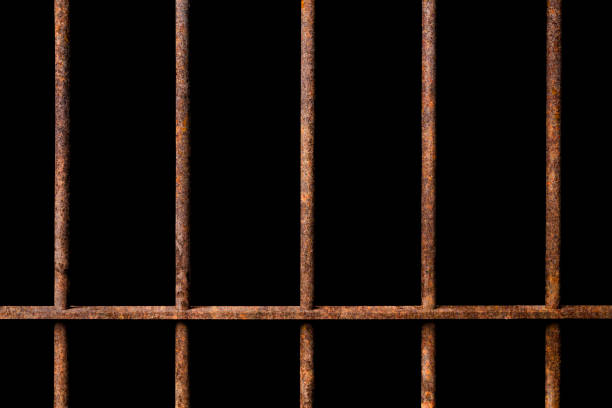 istock Old prison rusted metal bars cell lock on black background 1036645400