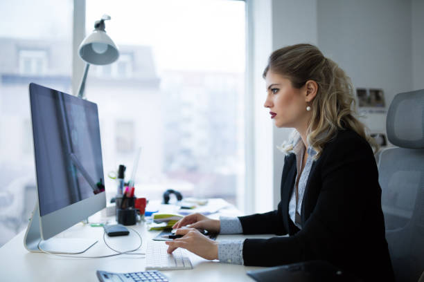 istock Attractive young female architect working on laptop 1036650286