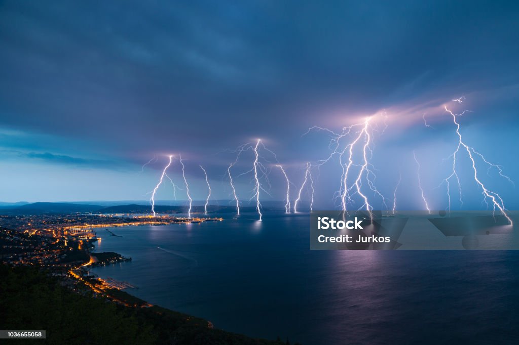 Sea City Lightning Storm Storm approaching sea city Trieste (Friuli Venezia Giulia region of Italy) from Gulf of Trieste. Lightning Stock Photo